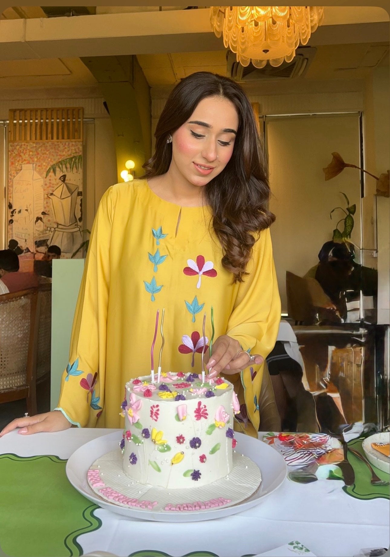 Woman in a yellow dress with floral patterns 